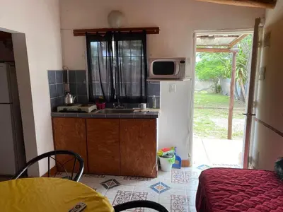 a small kitchen with a sink and a microwave at Cabañas la soñada de T in Tanti