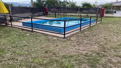 a pool in a yard with a fence around it at Cabañas la soñada de T in Tanti