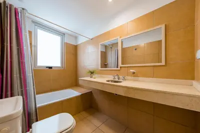 a bathroom with a sink and a toilet and a tub at Un Rinconcito en Guemes - Confort y Calidez in Cordoba