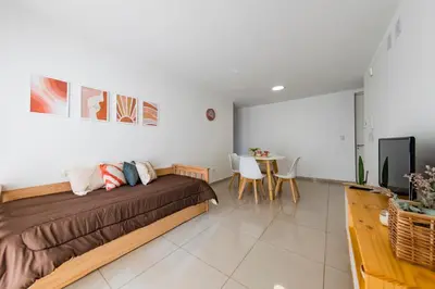 a bedroom with a bed and a table with chairs at Un Rinconcito en Guemes - Confort y Calidez in Cordoba