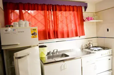 a small kitchen with a sink and a refrigerator at Casitas de Norma in Embalse