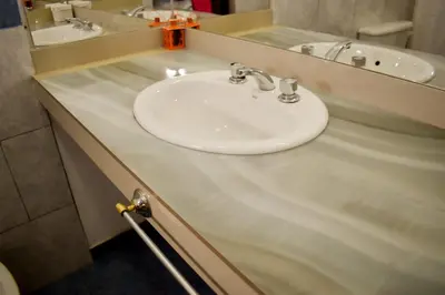 a bathroom with a white sink and a mirror at Casitas de Norma in Embalse