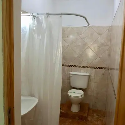 a bathroom with a toilet and a sink at Casitas de Norma in Embalse