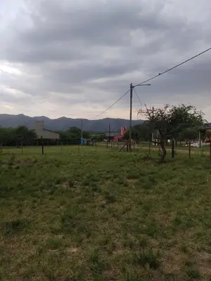 a field with a fence and a tree in a field at Cabaña en Los Reartes in Villa General Belgrano