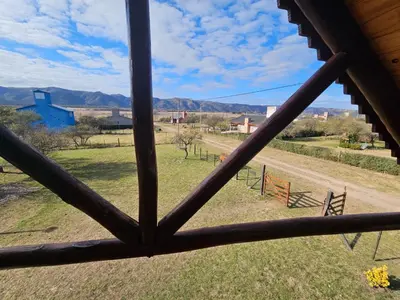 a view from a window looking out at a field at Cabaña en Los Reartes in Villa General Belgrano