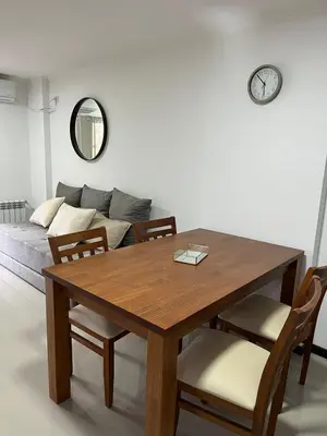 a dining room table with chairs and a couch at Departamento Veneto Village - D - in Villa Parque Siquiman