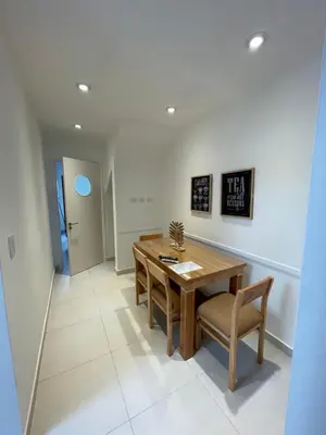 a dining room with a wooden table and chairs at Departamento céntrico y espacioso en Río Cuarto II in Río Cuarto