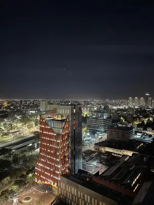 a city skyline at night with a tall building at Coral State in Cordoba