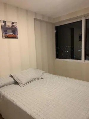 a white bed in a room with a window at Coral State in Cordoba
