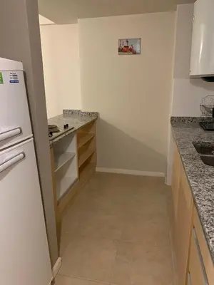 a small kitchen with a white refrigerator and counters at Coral State in Cordoba