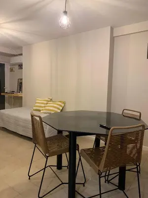 a dining room with a table and chairs and a bed at Coral State in Cordoba