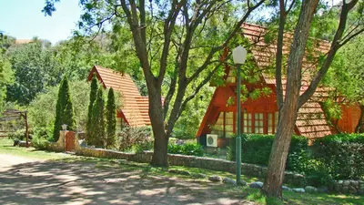 a house with trees and a street light in front of it at Cabañas Bosque Encantado in Merlo