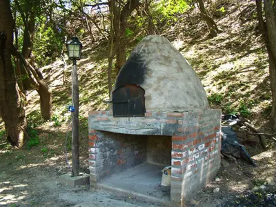 a brick oven sitting next to a street light at Cabañas Bosque Encantado in Merlo