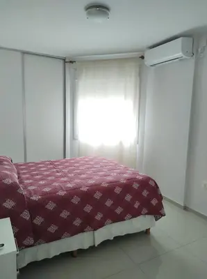 a bedroom with a bed in front of a window at Departamento Skala in Cordoba