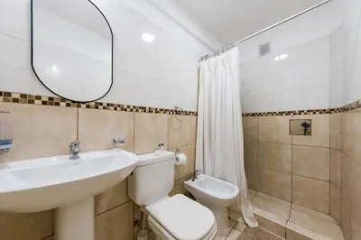 a bathroom with a sink and a toilet and a mirror at 24 de Septiembre 1859 B Gral Paz in Cordoba