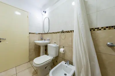 a bathroom with a toilet and a sink at 24 de Septiembre 1859 B Gral Paz in Cordoba