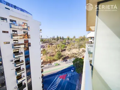 a view from the balcony of a building with a swimming pool at SERIETÁ Frente al PARQUE SARMIENTO in Cordoba