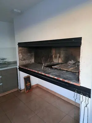 a fire place in a room with a fireplace at PRISMA CUARENTA in Villa Carlos Paz