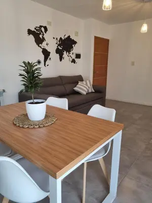 a living room with a wooden table with a plant on it at PRISMA CUARENTA in Villa Carlos Paz