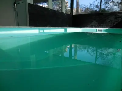 a large swimming pool with a reflection in the water at Hotel Sialdorf in Villa Carlos Paz