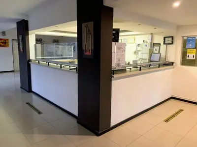 a restaurant with a counter in a building at Hotel Sialdorf in Villa Carlos Paz