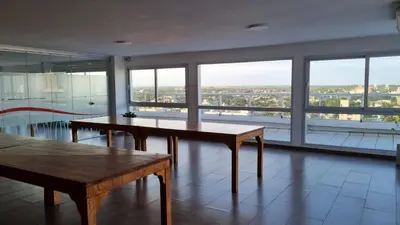a large room with two tables and a large window at Home in Río Cuarto