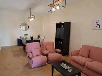 a living room with pink furniture and a table at Casa La Nona 5 personas con patio y quincho in Cordoba