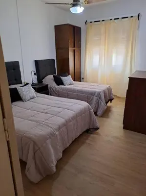 a room with two beds in a room at Casa La Nona 5 personas con patio y quincho in Cordoba