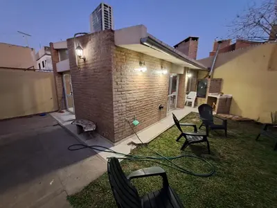 a house with a hose on the side of it at Casa La Nona 5 personas con patio y quincho in Cordoba
