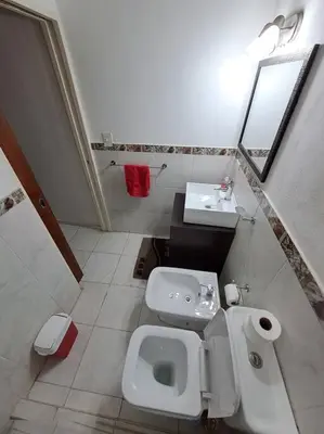 a small bathroom with a toilet and a sink at Casa La Nona 5 personas con patio y quincho in Cordoba