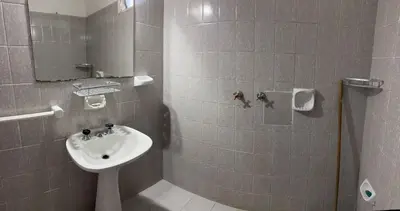 a small bathroom with a sink and a shower at Casa zona CUCÚ de 2 dormitorios in Villa Carlos Paz