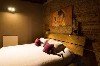 a bedroom with a bed with pillows and a brick wall at Puesto Victoria - Adults only in Yacanto