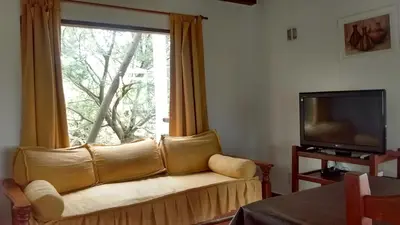 a living room with a couch and a window at Vista del Condor in Villa Ciudad de America
