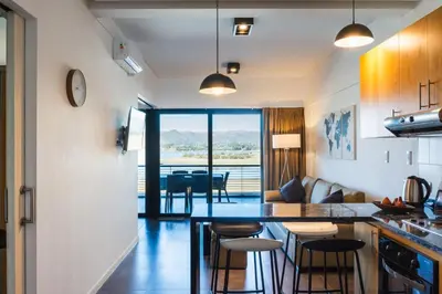 a kitchen and living room with a table and chairs at Depto - Lago los Molinos in Potrero de Garay