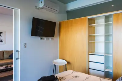 a bedroom with a bed and a tv and a closet at Depto - Lago los Molinos in Potrero de Garay