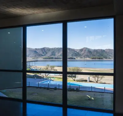 a view of a body of water from a window at Depto - Lago los Molinos in Potrero de Garay