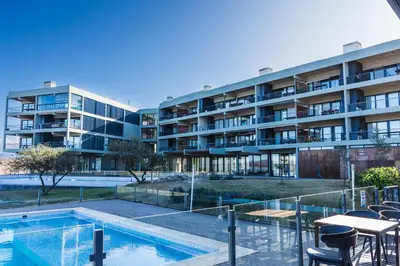 an apartment complex with a swimming pool and a building at Depto - Lago los Molinos in Potrero de Garay