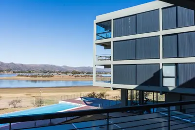 an external view of a building with a swimming pool at Depto - Lago los Molinos in Potrero de Garay