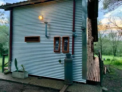 a metal building with a fire hydrant in front of it at NOMADE cabin rent in San Antonio de Arredondo