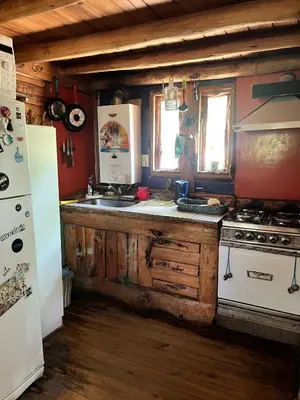 a kitchen with a stove and a refrigerator at NOMADE cabin rent in San Antonio de Arredondo