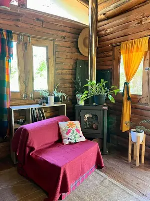 a bedroom with a bed and a fire place at NOMADE cabin rent in San Antonio de Arredondo
