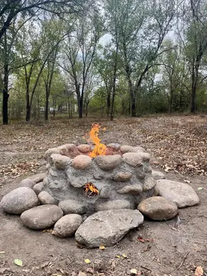a fire pit made out of rocks in a park at NOMADE cabin rent in San Antonio de Arredondo