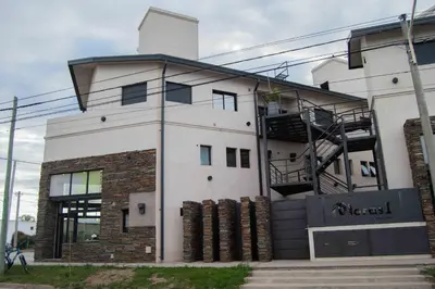 a building with a spiral staircase on the side of it at Complejo Moras I in Almafuerte
