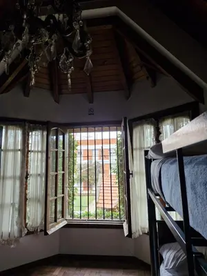a bedroom with two bunk beds and a window at Why Not Guemes in Cordoba