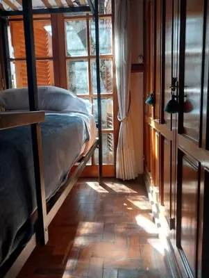 a bedroom with a bed in a room with a window at Why Not Guemes in Cordoba