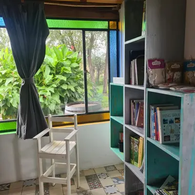 a white chair sitting in front of a window at Casa de campo boutique a 18 minutos de Merlo in Cortaderas