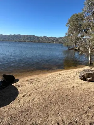 a view of a body of water with a sandy beach at Pasionaria Lake in Villa Parque Siquiman