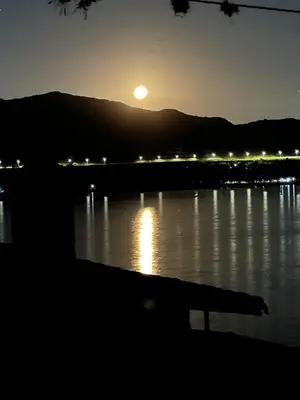 a sunset over a body of water with a bench at Pasionaria Lake in Villa Parque Siquiman