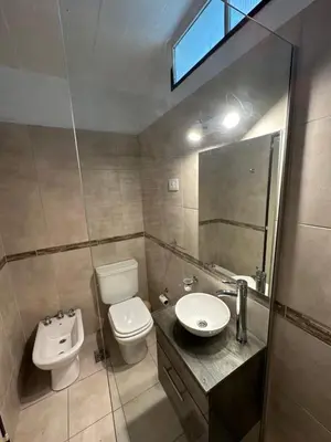 a bathroom with a toilet and a sink at Pasionaria Lake in Villa Parque Siquiman