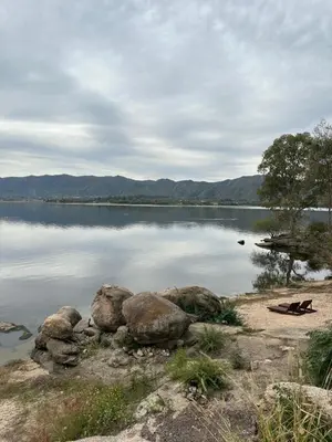 a large body of water with some rocks in it at Pasionaria Lake in Villa Parque Siquiman